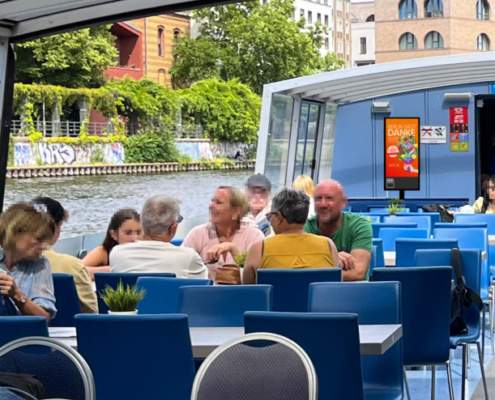 Digital_Screen_auf_Schiff_Berlin_sagt_danke Digitaler Screen mit Werbung auf dem überdachten Deck eines Ausflugsschiffs.